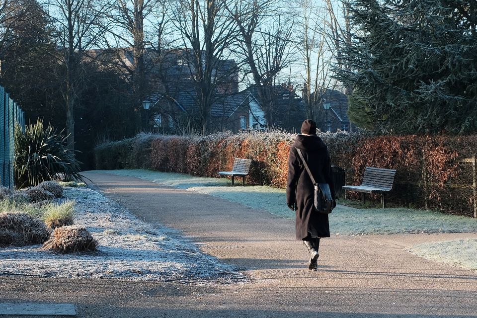 Woman walking to work on frozen morning