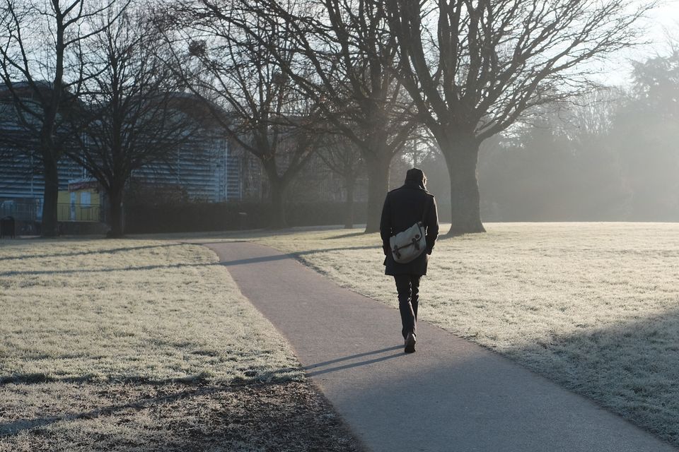 Man walking to work on frosty morning