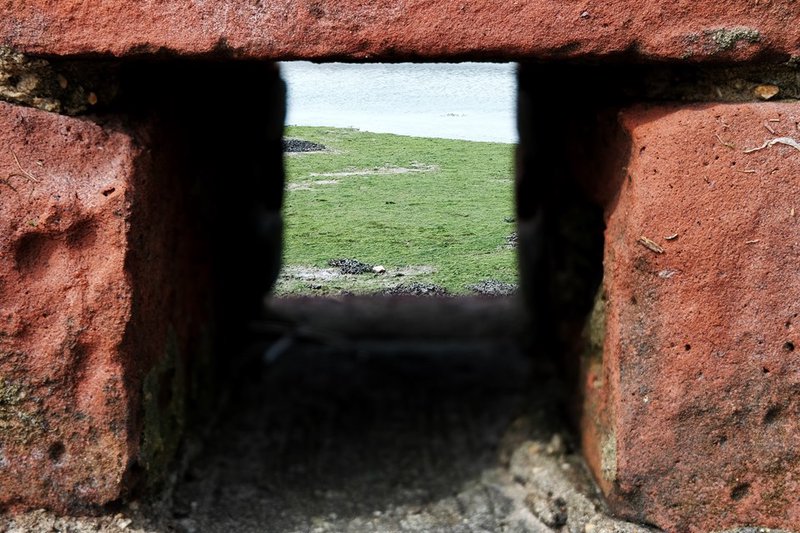 Through a hole in the wall